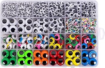 A plastic organizer box contains various sizes and colors of googly eyes. The compartments are neatly arranged, showcasing a vibrant and playful assortment.